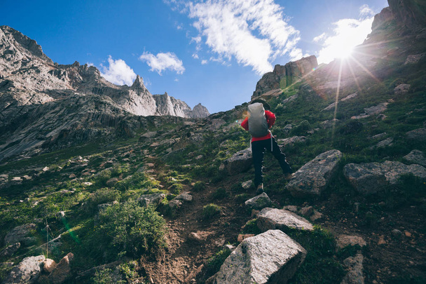 Woman hiker hiking at high altitude mountains   - Photo, image