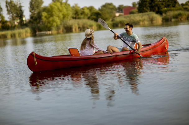 Loving couple rowing on the lake at summer day - Foto, Bild