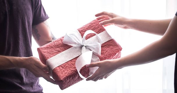 Close up portrait of man and women exchanging different presents - Photo, Image