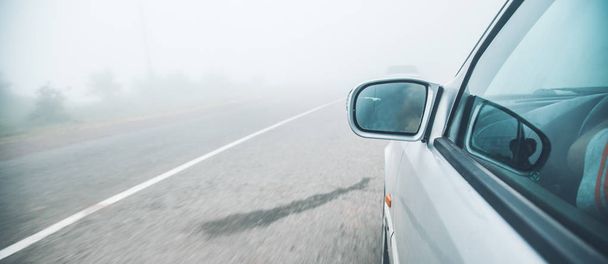 car on road in dark foggy evening - Фото, изображение