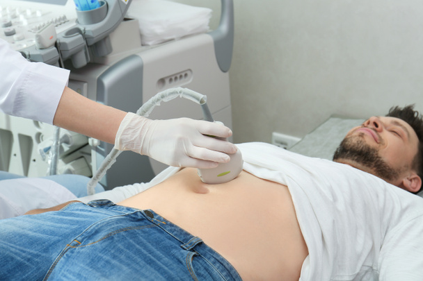 Γιατρός που διεξάγει υπερηχογραφική εξέταση εσωτερικών οργάνων στην κλινική - Φωτογραφία, εικόνα