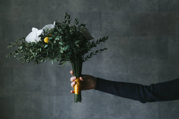 Beautiful bouquet of flowers in the hands of a woman - Фото, зображення