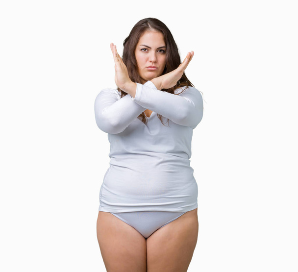 Beautiful plus size young overwight woman wearing white underwear over isolated background Rejection expression crossing arms doing negative sign, angry face - Photo, Image