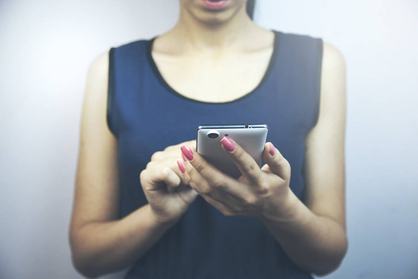 young  businesswoman hand phone in dark background - Fotó, kép
