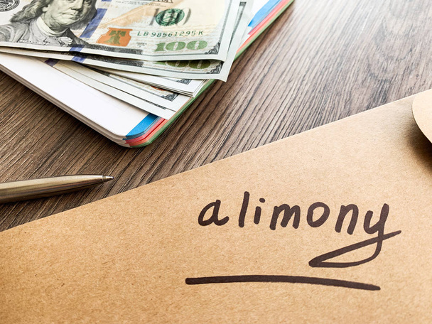 Payments alimony. White envelope with sign alimony and money. - Foto, Bild