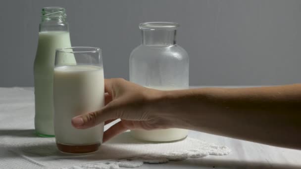 Hand picking up a glass of milk - Footage, Video