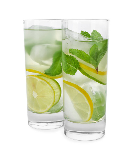 Glasses of refreshing drink with citrus slices and mint on white background - Foto, Imagen