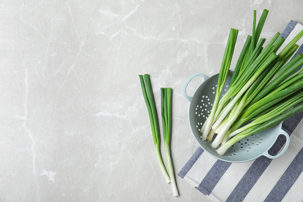 Flat lay composition with fresh green onion on marble background. Space for text - Fotó, kép