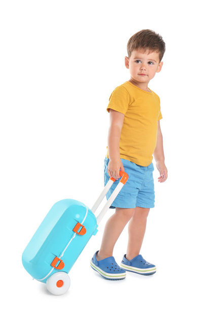 Cute little boy with blue suitcase on white background - Fotoğraf, Görsel