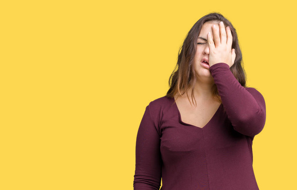 Beautiful and attractive plus size young woman wearing a dress over isolated background Yawning tired covering half face, eye and mouth with hand. Face hurts in pain. - Photo, Image
