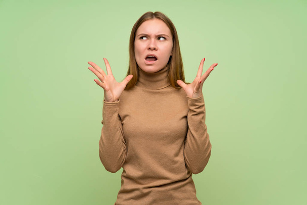 Young woman with turtleneck sweater frustrated by a bad situation - Fotoğraf, Görsel