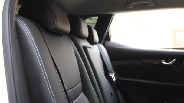 artificial leather rear seats in the car. beautiful leather car interior design. luxury leather seats in the car. Black leather seat covers in the car. - Footage, Video