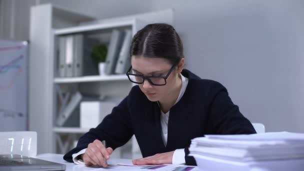 Satisfied lady bookkeeper looking through documents, feeling happy with work - Video, Çekim