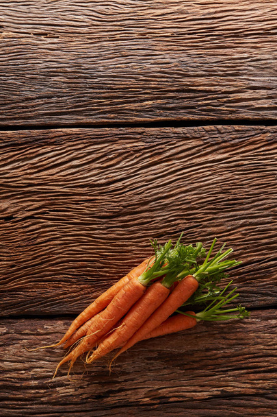 Baby carrot on wood - Fotografie, Obrázek