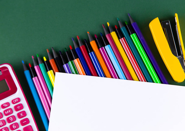 School office supplies stationery on a green background desk wit - 写真・画像
