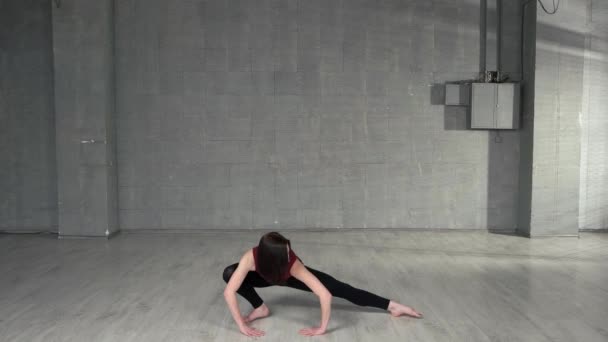 Young female dancer stretching in studio. - Footage, Video