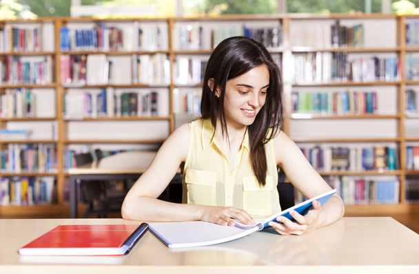 Porträt einer Studentin mit offenem Buch, das sie im Kolleg liest - Foto, Bild