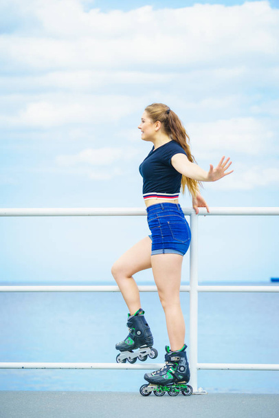 Girl wearing roller skates on seaside - Фото, зображення