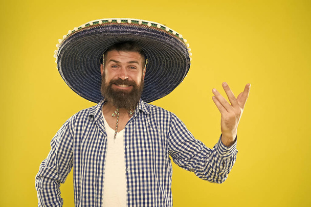 Mexican party concept. Celebrate traditional mexican holiday. Lets have fun. Mexican guy happy festive outfit ready to celebrate. Man bearded cheerful guy wear sombrero mexican hat yellow background - Valokuva, kuva