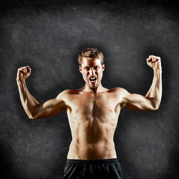 Crossfit fitness man flexing strong on blackboard - Фото, зображення