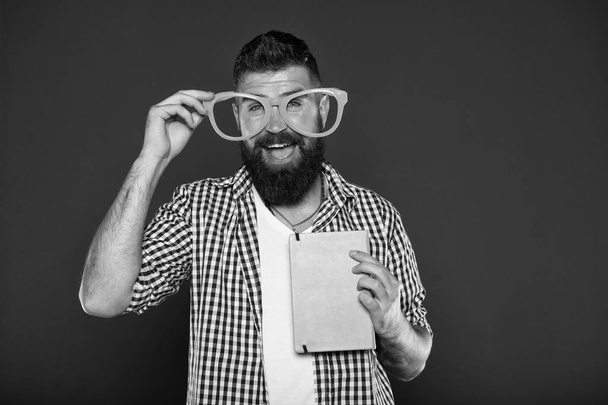 Super smart. University male student with lecture notes. Book nerd wearing fancy glasses. Bearded man in party glasses with lesson book. Study nerd holding book - Fotografie, Obrázek