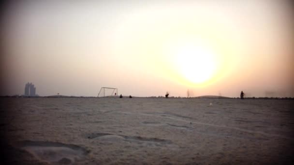 Παίζοντας ποδόσφαιρο ενώ το ηλιοβασίλεμα-ημέρα σε νύχτα-λήξη κίνησης - Πλάνα, βίντεο