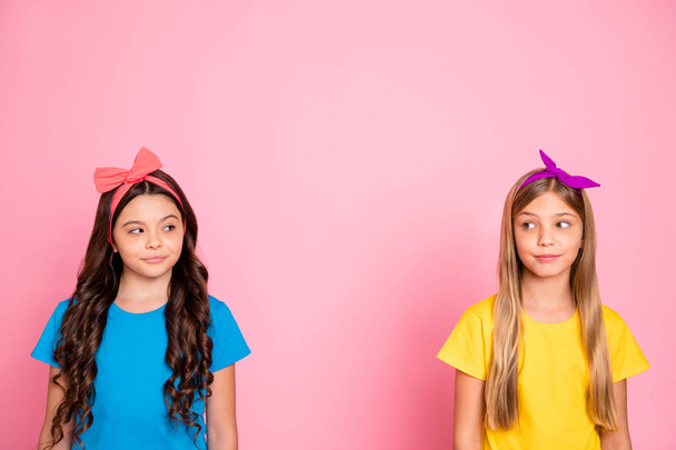Portrait of two nice-looking attractive well-groomed winsome charming cute lovely friendly cheerful cheery pre-teen girls looking at each other isolated on pink pastel background - Foto, Imagen