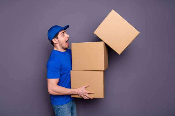 Close up photo profession yelling he him his deliveryboy hold hands large big heavy parcel boxes exhausted stressed catch upper breakable one wear blue t-shirt cap jeans denim isolated grey background - Photo, Image