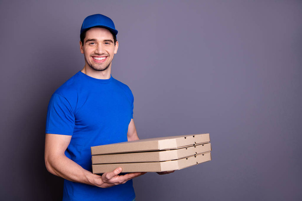 Close up side profile photo express specialist he him his deliveryboy hold strong arms three parcel boxes toothy smile come in time wear blue t-shirt cap corporate suit isolated grey background - Foto, Imagem