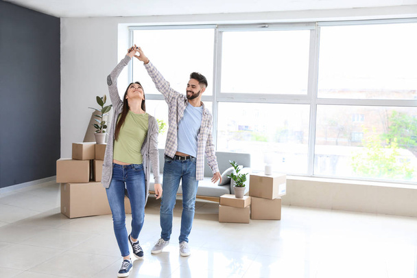 Young couple dancing in their new house - Photo, Image