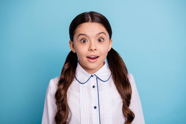 Portrait of astonished kid open mouth wear white blouse isolated over blue background - Фото, изображение