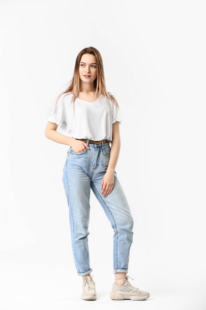 Stylish young woman in jeans on white background - Фото, зображення