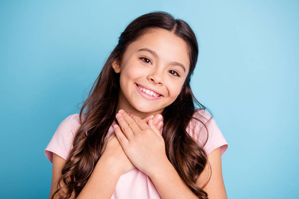 Close up photo of charming adorable child touch place palms hands chest feel rest neck feel relaxed peaceful she stylish light-colored fashionable outfit isolated on blue background - 写真・画像