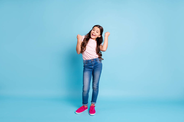 Full length body size view photo content cute kid lucky scream yeah goals fan free time weekend relax rest raise fists ecstatic reaction funky jeans clothes fuchsia shoes isolated blue background - Valokuva, kuva