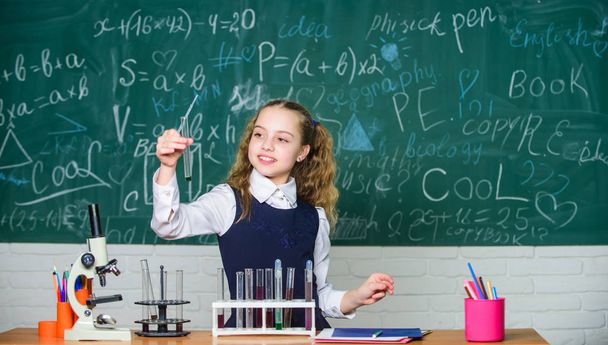 Future microbiologist. School laboratory. Girl smart student conduct school experiment. School pupil study chemical liquids. School chemistry lesson. Test tubes with substances. Formal education - Valokuva, kuva