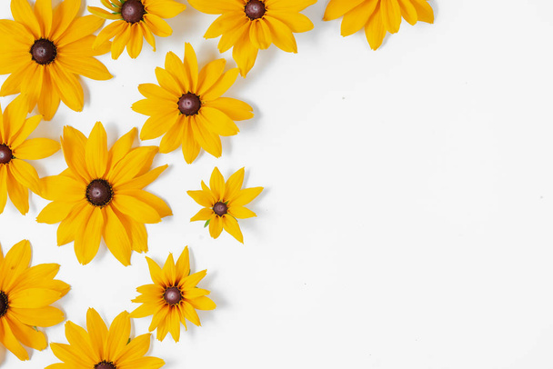 Flowers composition. Pattern made of yellow flowers on white background. Summer and autumn concept. Flat lay, top view, copy space - Fotoğraf, Görsel