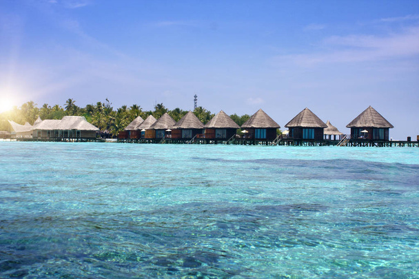 houses over transparent quiet sea water- tropical paradise, Maldives - Photo, Image