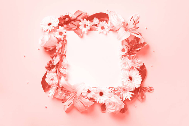 Spring composition of white flowers on trendy coral color background with copy space. Creative layout. Flat lay. Top view. Summer minimal concept. - 写真・画像