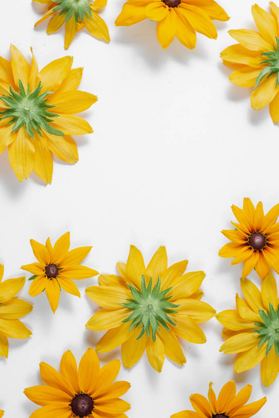 Flowers composition. Pattern made of yellow flowers on white background. Summer and autumn concept. Flat lay, top view, copy space - Foto, Bild