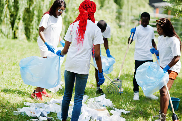 Group of happy african volunteers with garbage bags cleaning are - Zdjęcie, obraz