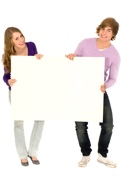 Young couple holding a billboard - Fotó, kép