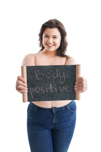 Plus size woman holding board with text BODY POSITIVE on white background - Fotó, kép