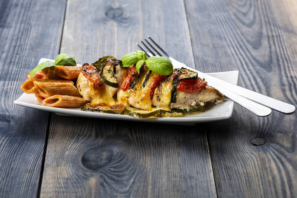 baked chicken breast with mozzarella and vegetables - Fotó, kép
