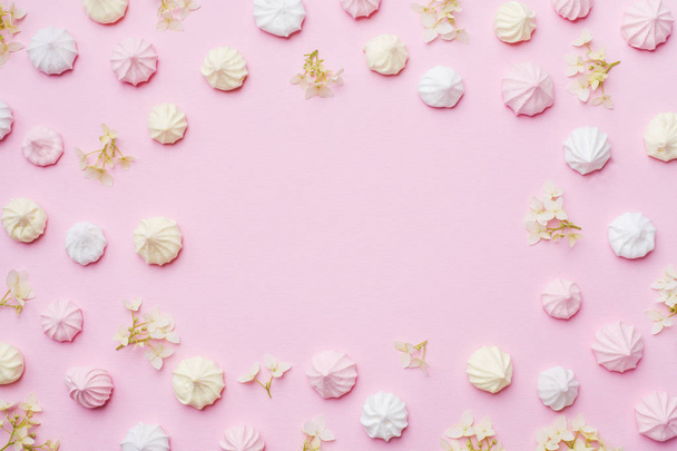 Colored small meringues on a pink background. Flat lay concept. Copy space. - Φωτογραφία, εικόνα
