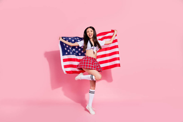 Full body profile photo of pretty lady carry usa flag college university english marsh wear white top short plaid skirt isolated pink background - Foto, imagen