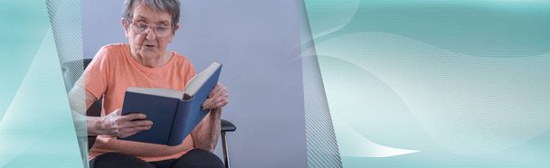 Old woman reading a book; panoramic banner - Photo, Image