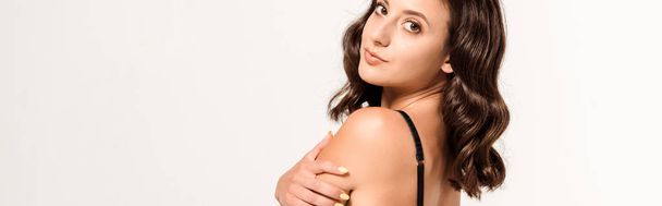 panoramic shot of attractive woman in black bra looking at camera on white  - Foto, Imagen
