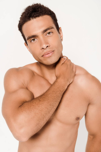 handsome and muscular mixed race man touching neck on white   - Foto, Imagem