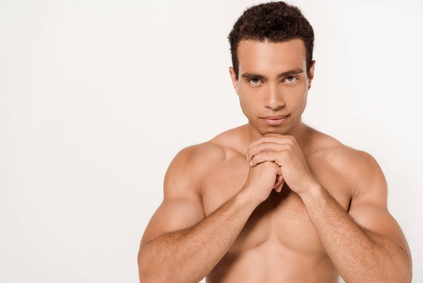 handsome and muscular mixed race hand with clenched hands on white  - Foto, afbeelding