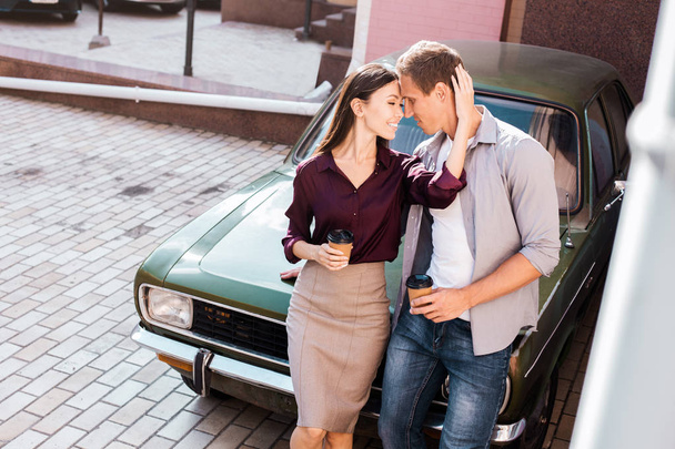 Travelling by car on holiday. Love relationship and romance. Man and woman next to their new car. Couple in love in autumn city. Happy couple enjoying moment fall in love, couple walking outdoor. - Foto, Bild
